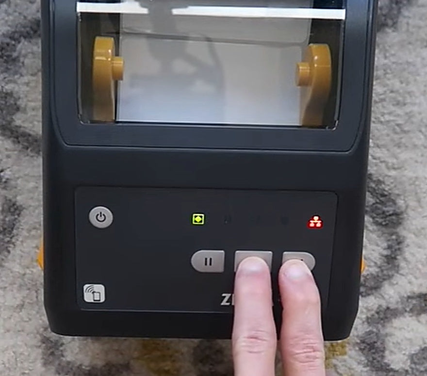 Press and hold Cancel + Feed together to print the network configuration label.