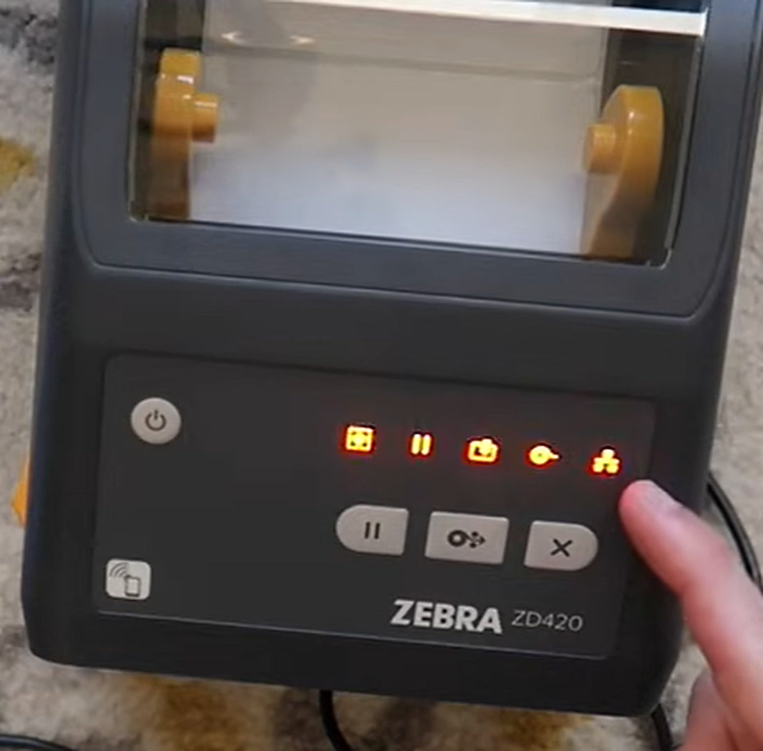 The network status light is lit while the printer applies the new settings and reconnects.