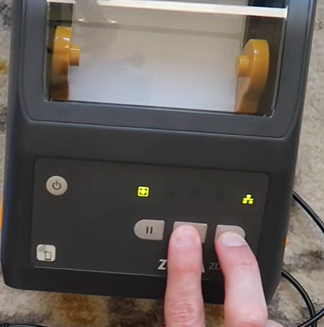 Press and hold Cancel + Feed together to print the network configuration label.