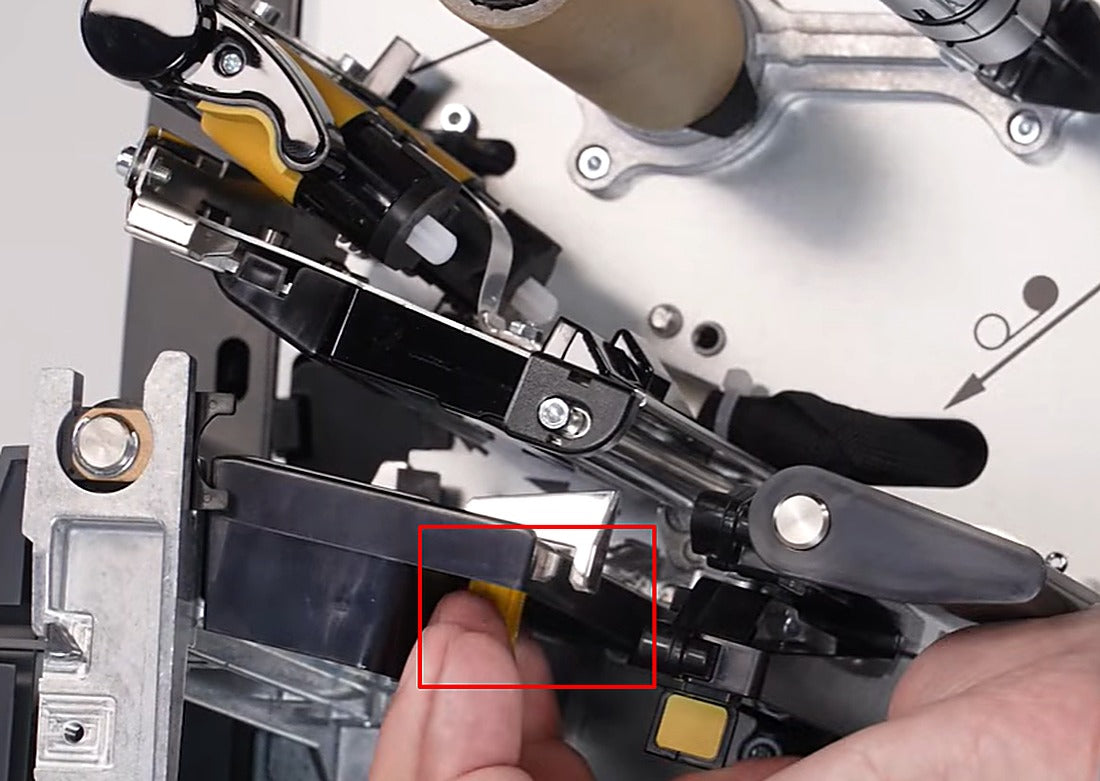 Thread the ribbon through the printhead assembly along the path shown.