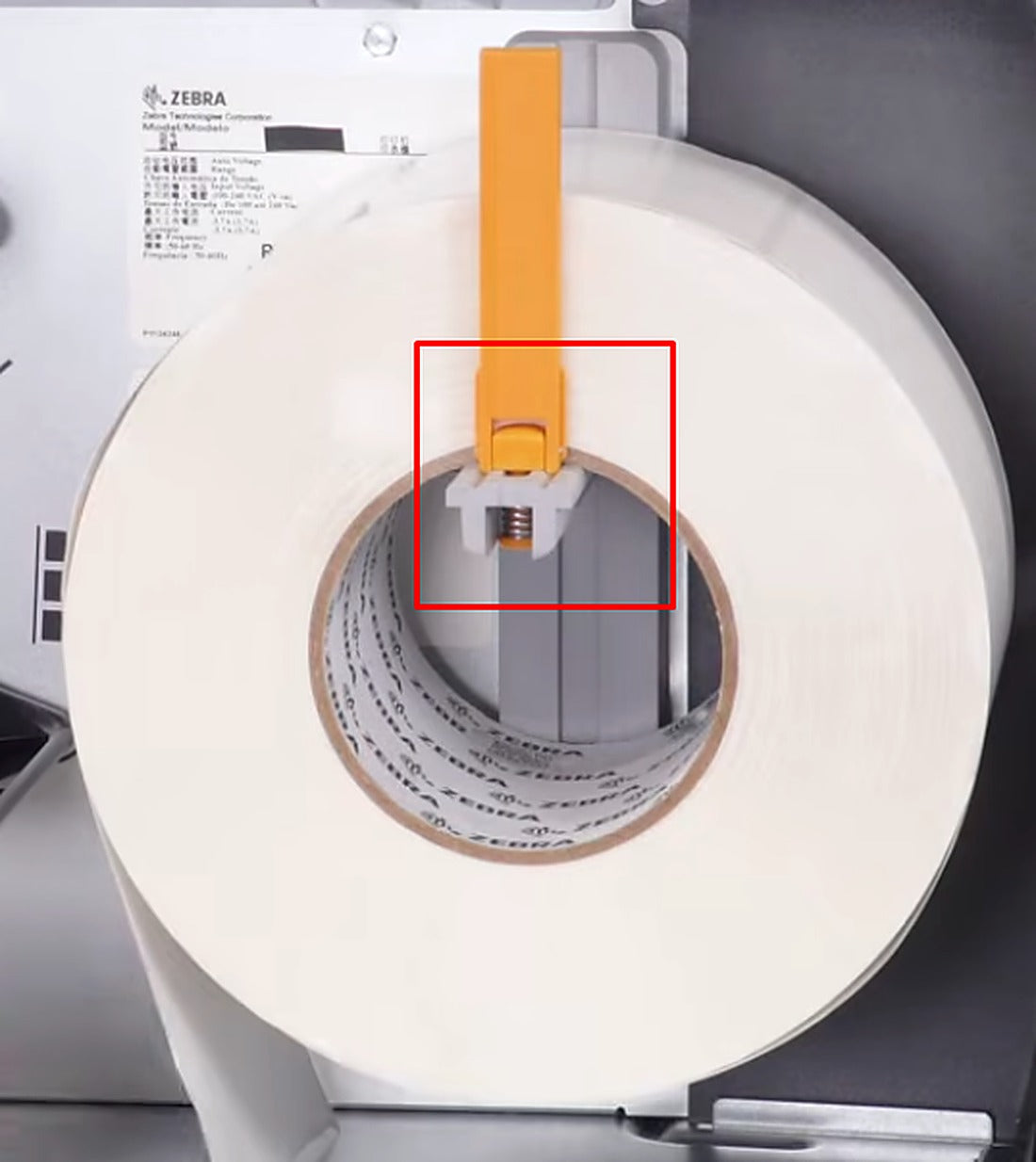 Slide an empty ribbon core onto the take-up spindle.