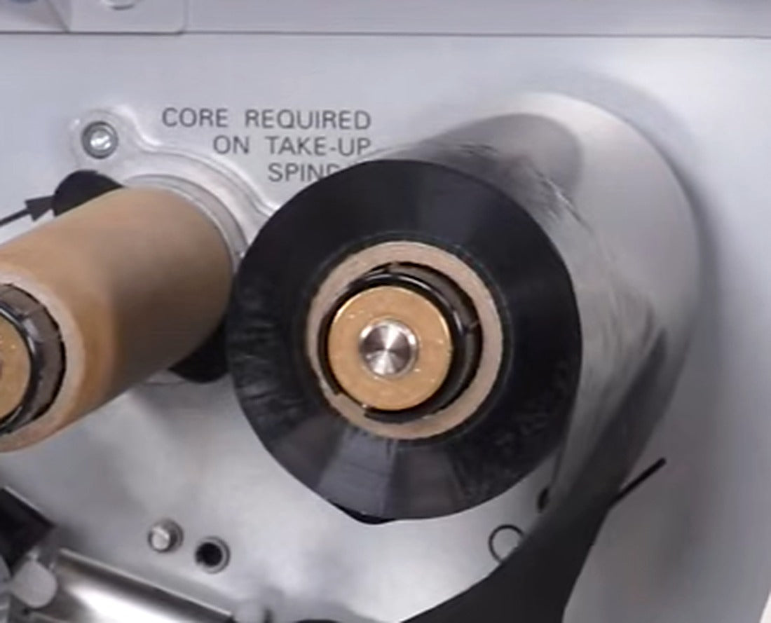 The ribbon should wind smoothly and evenly onto the take-up spindle.
